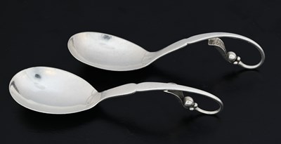 Lot 71 - Georg Jensen, two silver preserve spoons,...