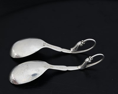 Lot 71 - Georg Jensen, two silver preserve spoons,...