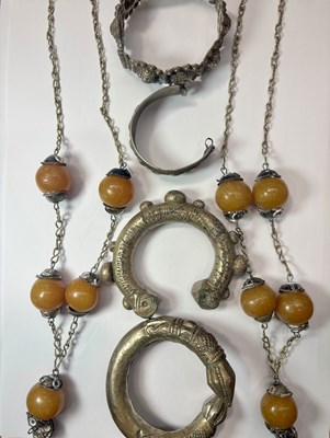 Lot 230 - Four white metal bangles and two orange plastic bead necklaces