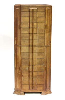 Lot 76 - A tall oak music cabinet in the manner of Heal'...