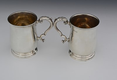 Lot 87 - A pair of George V silver pint mugs, by...