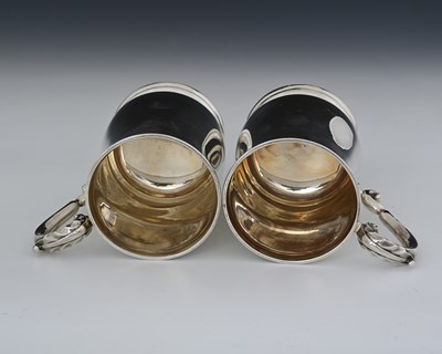 Lot 87 - A pair of George V silver pint mugs, by...