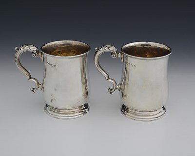 Lot 87 - A pair of George V silver pint mugs, by...