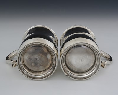 Lot 87 - A pair of George V silver pint mugs, by...