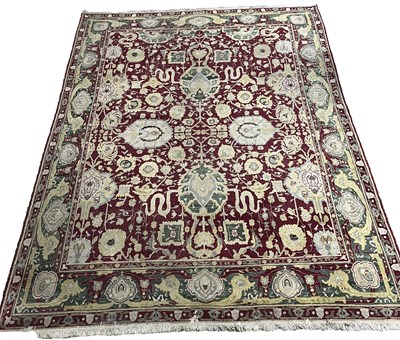 Lot 649 - A large Agra 'jail' rug or carpet, claret...