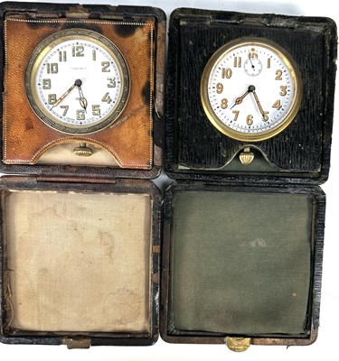 Lot 280 - Two leather-cased eight-day travel clocks, one...