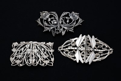 Lot 303 - Three Elizabeth II cast silver buckles, to...