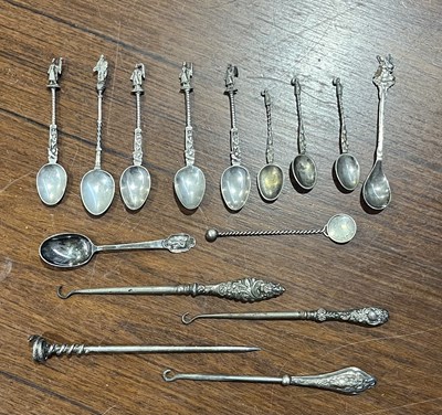 Lot 482 - Silver handled button hooks; a white metal...
