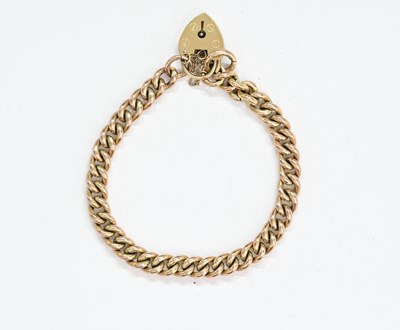 Lot 476 - A 9ct gold curb-link bracelet with heart padlock clasp