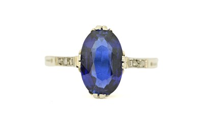 Lot 420 - An oval-shape sapphire and rose-cut diamond ring