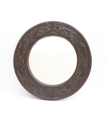 Lot 440 - A carved oak wall mirror in the manner of the...