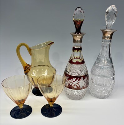 Lot 150 - A cranberry and clear flash cut glass decanter...
