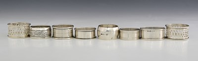 Lot 341 - A group of eight silver napkin rings,...