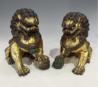 Lot 161 - A pair of painted cast iron lion or Foo Dog,...