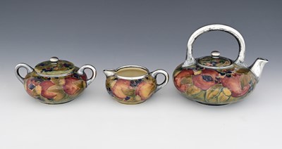 Lot 21 - 'Pomegranate' a rare Moorcroft Pottery three...