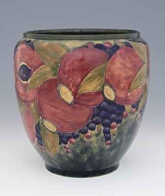 Lot 221 - William Moorcroft, a Pomegranate on ochre vase...