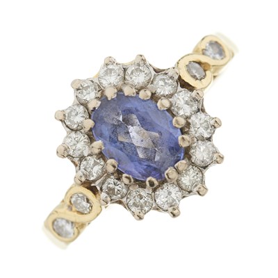 Lot 124 - An 18ct gold tanzanite and diamond cluster ring