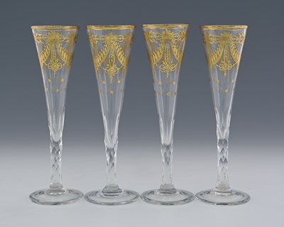 Lot 583 - A set of four gilt decorated Champagne flutes,...