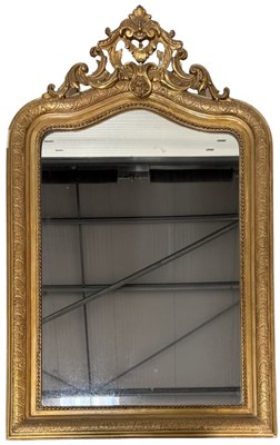 Lot 648 - A gilt plaster wall mirror, rounded ogee...