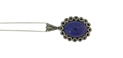 Lot 456 - A silver tanzanite cabochon and single-cut diamond cluster pendant