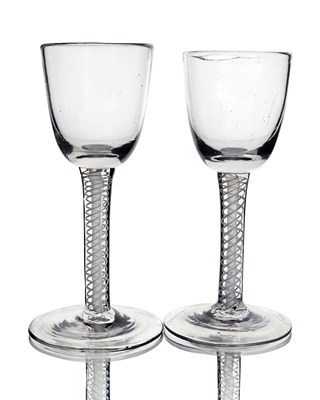 Lot 566 - A near pair of opaque twist wine glasses,...