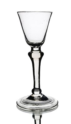 Lot 574 - A light balsuter wine glass, circa 1730, the...