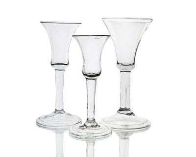 Lot 579 - Three graduated plain stemmed wine glasses,...