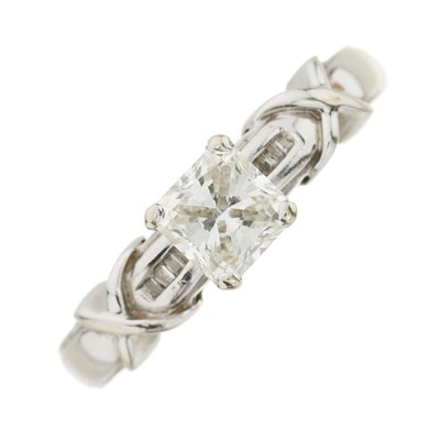 Lot 86 - A modified princess-cut diamond ring, with baguette-cut diamond shoulders