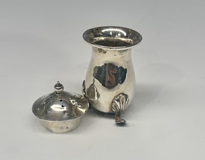 Lot 209 - A silver pepper pot with tripod feet and...