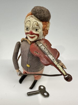 Lot 185 - A Schuco mechanical clown with violin, in felt...