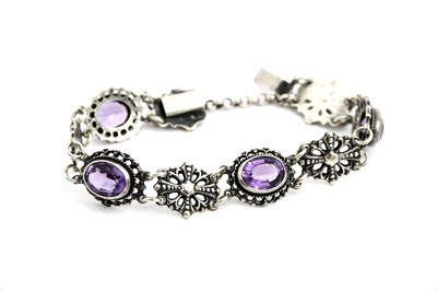 Lot 552 - A silver and amethyst link bracelet, alternate...