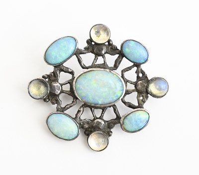 Lot 557 - A silver and opal brooch in the manner of Amy...