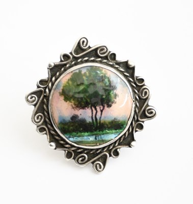 Lot 567 - A silver and enamel brooch in the manner of...