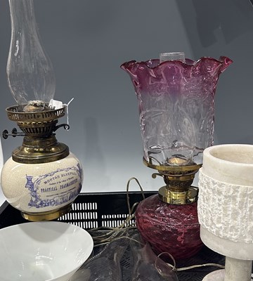 Lot 54 - Two oil lamps, one with a diamond-moulded...
