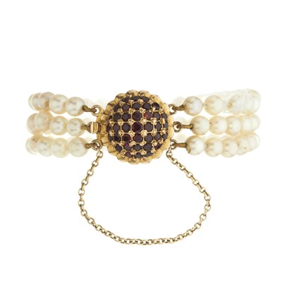 Lot 48 - A mid 20th century three strand cultured pearl bracelet, with 9ct gold garnet cluster clasp