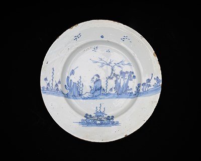 Lot 644 - An English Delft blue and white charger, circa...
