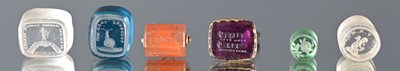 Lot 390 - A selection of loose paste intaglio seals and two fobs