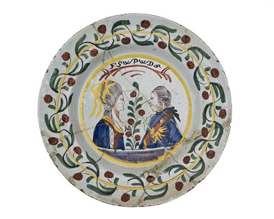 Lot 609 - A Dutch Delft polychrome commemorative charger...