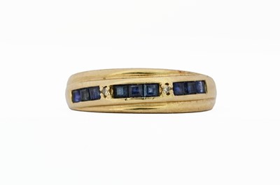 Lot 416 - A sapphire and brilliant-cut diamond half eternity ring