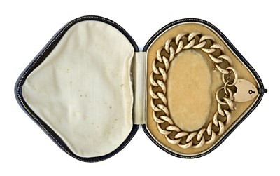 Lot 482 - An early 20th century 9ct gold curb-link bracelet with heart padlock clasp