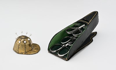 Lot 535 - A stamped metal Jockey Cap pin cushion,...