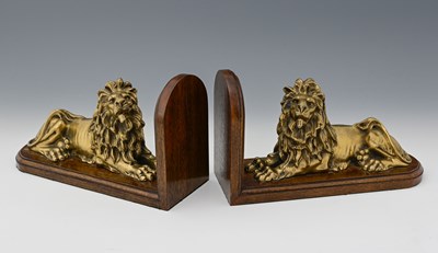 Lot 533 - A pair of gilt bronze recumbent lions, each...