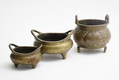 Lot 121 - Three graduated Chinese bronze censers,...