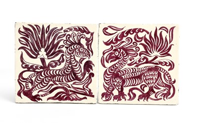 Lot 128 - A pair of Grotesque Animal tiles designed by...