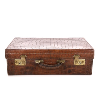 Lot 499 - A vintage brown crocodile suitcase, featuring...