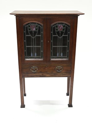 Lot 438 - A Glasgow School oak cabinet retailed by...