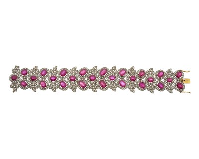 Lot 126 - A glass-filled ruby and brilliant-cut diamond foliate cluster bracelet
