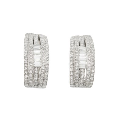 Lot 173 - A pair of brilliant-cut and baguette-cut diamond half hoop earrings