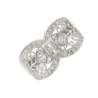 Lot 213 - A brilliant-cut and emerald-cut diamond scrolling openwork band ring