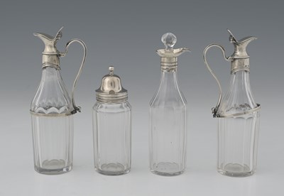 Lot 239 - Four George III silver-mounted glass condiment...